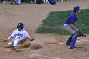 Brad Wilson slides home with the tying run for the Huskies, on a Conor Szczerba single in the seventh.